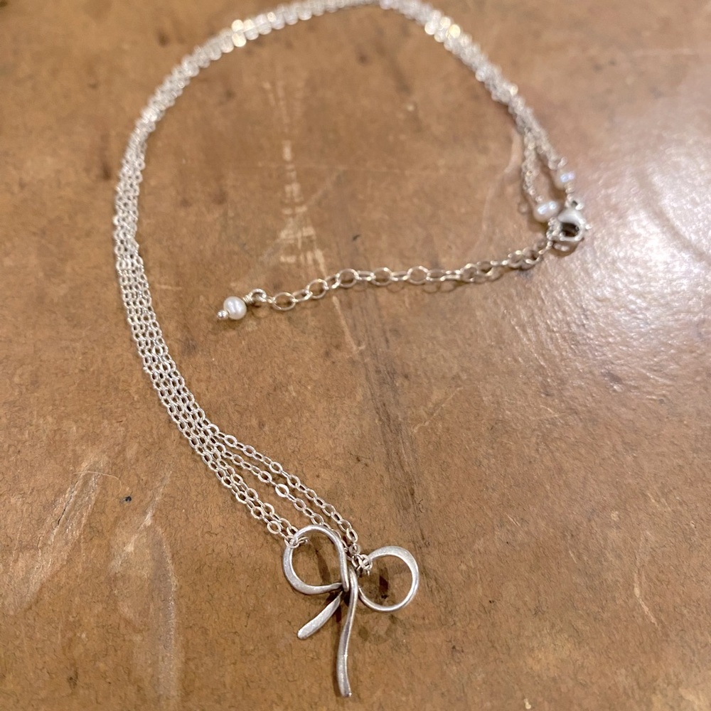 Delicate bow charm and chain with faux pearl accents